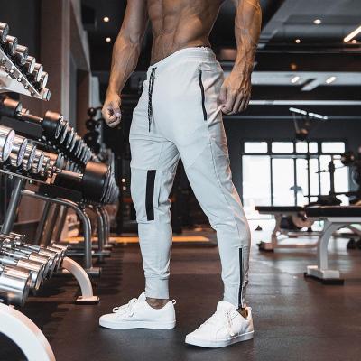 China Custom Logo Polyester Blank Drawstring Track Fitness Wear Sweatpants Elastic Waist Gym Jogging Running Pants Breathable With Zipper Pockets for sale