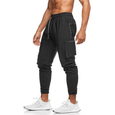 China Custom Mens Cargo Track Pants Polyester Breathable White Elastic Tight Narrow Pocket Zipper Pocket Jogging Joggers Cargo Track Pants for sale