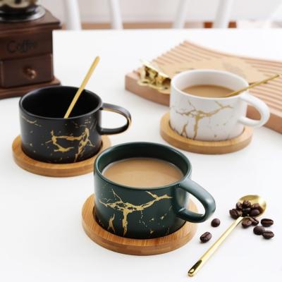 China Modern Design 175ml Gold Marble Green Matte Glaze Ceramic Coffee Cups Black White With Wooden Saucers for sale