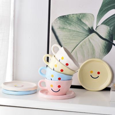 China Promotional New Type Stocked Ceramic Cups And Saucers Smile Face Porcelain Tea Colorful Coffee Set for sale