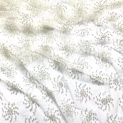 China Hot Viable Wholesale Bridal Crystal Heavy Beaded Lace White Beaded Lace Fabric Fabric For Dress for sale