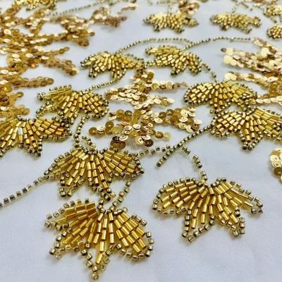 China Sustainable luxury gold fully beaded fabric bridal crystal sequins heavy beaded fabric with tube for dress for sale