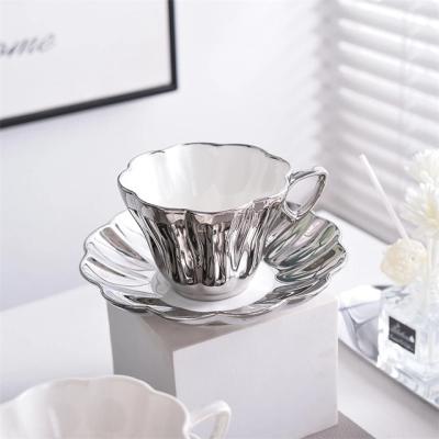 China Sustainable New Design Pearl White Luxury Silver Petal Cup And Saucer For Cafe Creative Elegant Ceramic Tea Cup Set Home Party Tableware for sale