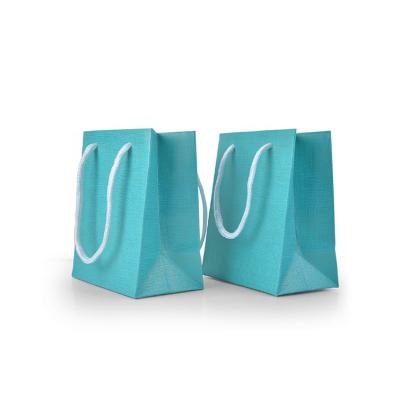 China Recycled Materials Customized Royal Blue Embossed Special Paper Jewelry Gift Shopping Small Size Paper Bags for sale