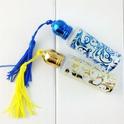 China Empty Fashion 10ml Cosmetic Flower Painted Amber Glass Roll On Perfume Bottle With Tassels for sale