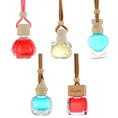 China Recyclable Factory OEM Cute Glass Bottle Car Pendant Multifunctional Perfume Bottle With Lovely Pendant for sale