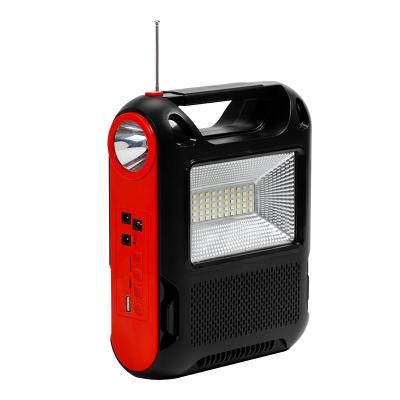 China Easy Replace Battery SUNWELL Multifunctional Outdoor Camping Flashlight Music FM Charging Solar Rechargeable LED Work Light for sale