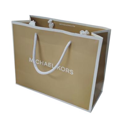 China Recycled Materials STPP Developed Customized Printing Famous Brand Fashion Handle Apparel Shopping Bag For Euro Clothes Kraft Paper Bags for sale