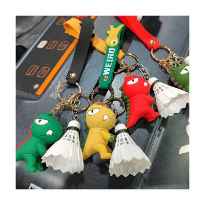 China Soft rubber Wholesale New Style Fashion  3D Soft Rubber Cute Little Dinosaur Keychain With Badminton Custom Logo for sale