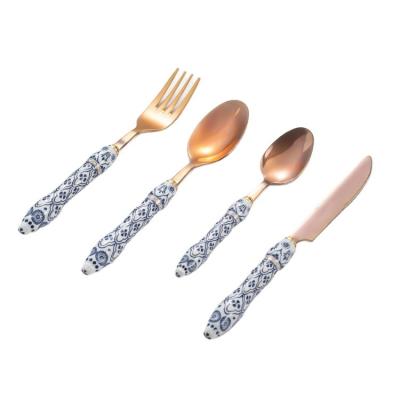 China Sustainable Vintage Rose Gold Kitchen Flatware Metal Knife Fork Spoon Set With Blue And White Porcelain Handle for sale