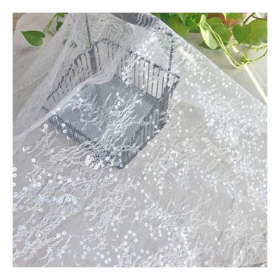 China Wholesale 100% Tulle Breathable Nylon Lace Fabric Wedding Hollow Floral Dress White Lace Sequins Fabric For Bridal Dress for sale