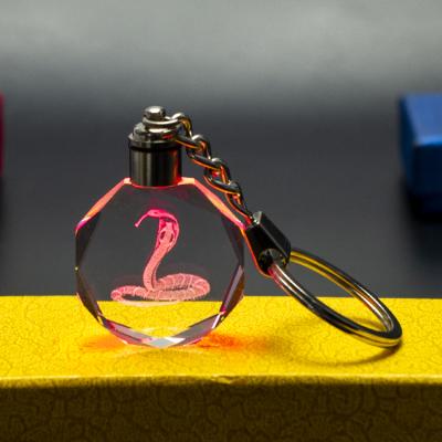 China 2022 modern snake's fashionable UV printing crystal led key chain high quality glass crystal K9 keychains for sale