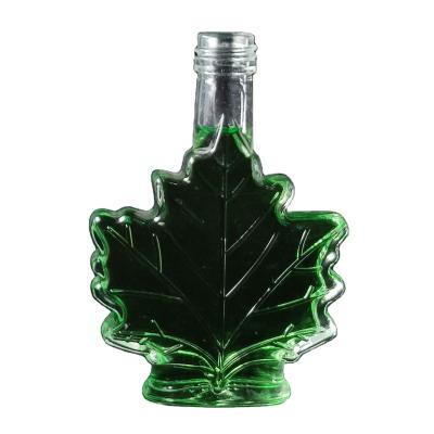 China Unique Beverage 100ml Leaf Shape Glass Bottle Small Shape Bottle For Liquor for sale