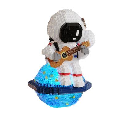 China Space Puzzle Components Luminous Children's Building Toy Hot Sale Toy Amazon Earth Astronaut Doll Plastic Model for sale