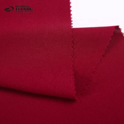 China Fashionable Design Woven Memory Plain Dyed Red Color Polyester Korean Foam Crepe Fabric Microfiber Tailoring for sale