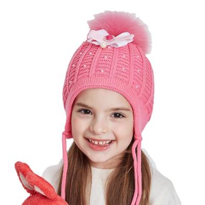 China Cute Rhinestone Girls Winter Knitted Beanies With Bright Natural Fur Pompom Pearl Bow-knot Ear Flap Kids Hats Wholesale Warm Toddler Hat for sale