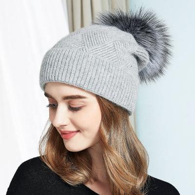 China COMMON Winter Natural Fur Pompom Knitted Hats For Women Fashion Wide Cuff Cashmere Beanies Custom Made for sale