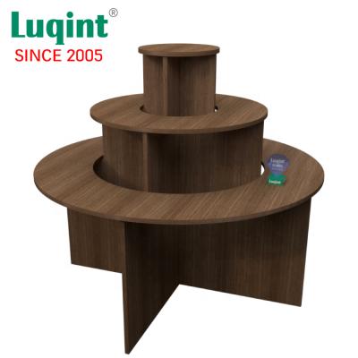 China Commercial Wooden Top Tiered MDF Board Clothes 3 Tiered Retail Display Round Table for sale