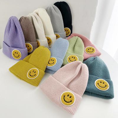 China COMMON classic hat autumn and winter female smiling face labeling couples knitted hat fashion thick winter sweater wool hat for sale