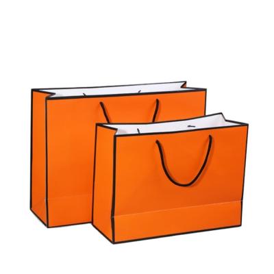 China Recycled Materials Custom Printed Matte Horizontal Orange For Carrying Gift Goodie Apparel Clothing Paper Bag Dongguan Printing Shopping Manufacturer for sale