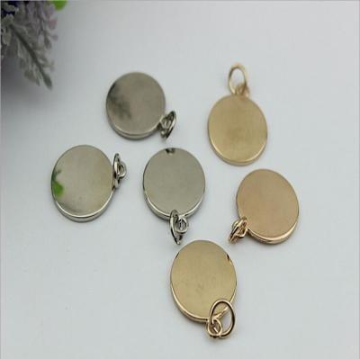 China Handbag hardware metal round shape flat logo label tag plate with light gold for sale