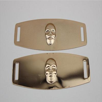 China Eco-friendly plating iron sheets gold color embossed skull logo shoe metal buckles for shoelace for sale