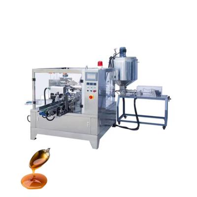 China Rotary Style Automatic Corner Pouch Spout Food Premade Syrup Packaging Machine With Piston Filler Liquid for sale