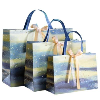 China Recyclable Hot Sell New Design Luxury Paper Bags With Ribbon Handle for sale