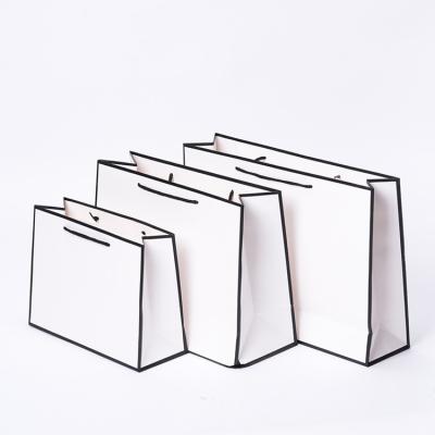 China Recycled Materials Wholesale Price Fashionable Gift Paper Bag Custom Your Own Logo for sale