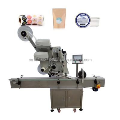 China Hot Sale Food Automatic Label Applicator Flat Cans Multifunctional Automatic Top Labeling Machine for sale