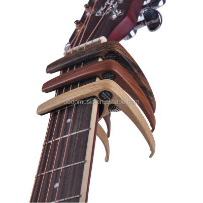 China Latest GUITAR wooden design natural/Sapele/Rosewood color guitar capo with Bridge Pin Puller for Acoustic and Electric Guitar for sale