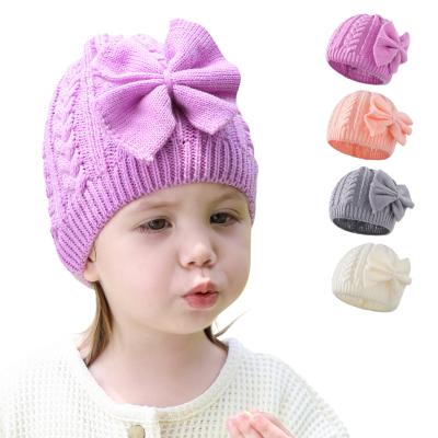 China New Cozy Woolen Bow Knit Warm Children's Winter Hat Twist Children's Hat Dome Cap for sale