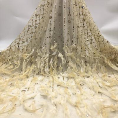 China Viable Fashion Feather Tulle Gold Lace With Shiny Crystal Sequins Net Embroidery Beads Fabrics For Wedding for sale