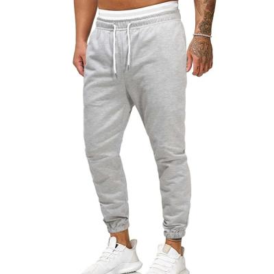 China Anti-wrinkle OEM service cheap wholesale men sweatpants custom logo solid color drawstring waist tracker pants for sale