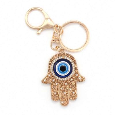 China For New Fashion Style Rhinestone Decoration Crystal Gold Hand Key Ring Key Chain For Key Bag Car Evil Eye Keychains for sale