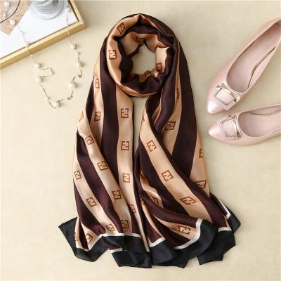 China Elegant / Fashion 2021 Spring Z Letter Printing Silk Scarf Women Stripe Satin Shawls 180*90 for sale