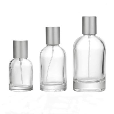 China Eco-friendly custom round empty clear cosmetics spray bottle 30ml 50ml 100ml glass perfume creative perfume bottle with cap for sale