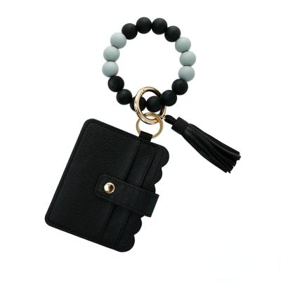 China Promotional Gifts Leather New Silicone Key Chain PU Tassel Bag ID Card Holder Pearl Bracelet Wristband Key Chain for sale