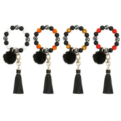 China Promotional Gifts Halloween Silicone Hair Ball Tassel Wristband Wristband Key Chain Beaded Keychain for sale