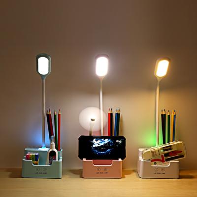 China Modern Multifunctional Study Lamp With Flexible Pen Holder And Mobile Phone Stand Reading Desk LED Table Lamp for sale