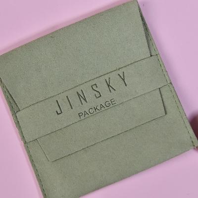 China Custom Embossed Jewelry Packaging JINSKY Logo Microfiber Envelope Jewelry Pouch With Strap for sale