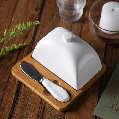 China Western Restaurant Stocked Used Eco-Friendly Creative Rectangle White Ceramic Butter Dish With Knife Set for sale