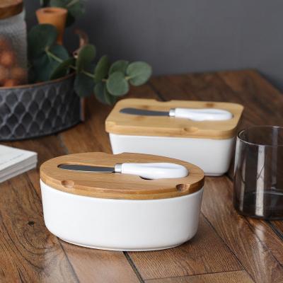 China Hot Selling Rectangle Oval Shape Stocked Ceramic Butter Knife Set Ceramic Butter Dish With Wooden Lid for sale