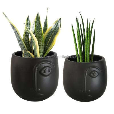 China 2021 Modern New Product Ceramic Black Matte Face Shaped Decorative Indoor Herb Garden Planter Flower Pots for sale