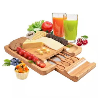 China Best Viable Selling Kitchen Bamboo Cheese Cutting Board With Hidden Slide Drawer Cheese Knife Set for sale