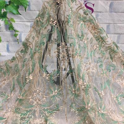 China Gold Luxury Sustainable Yarn Tulle Lace Fabric Bridal Net Embroidery Lace Fabric With Sequins for sale