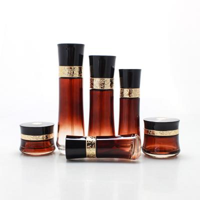 China Luxury Wholesale Gradient Red Cosmetic Jar Lotion Cream Glass Jar With Gold Pump Gold Cap for sale