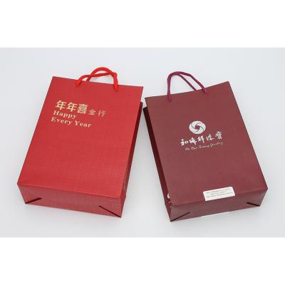 China Gifts Customized Dark Red Color Paper Bag Gift Packaging Jewelry Bag With Gold Stamping Logo for sale