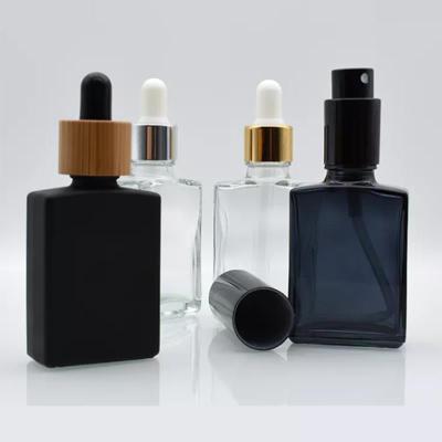 China Personal Care Rectangle Shape Black Glass 30ml Serum Dropper Bottle For Essential Oils With Packing Box for sale