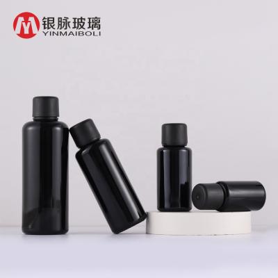 China Wholesale Customized Personal Care 10ml 15ml 30ml 50ml Essential Oil Black Glass Bottle With Plastic Lid for sale